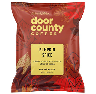 A red and orange Door County Coffee 'Pumpkin Spice' medium roast coffee bag, displayed on a white background with promotional text above and below.