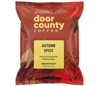 A bag of Door County Coffee Autumn Spice medium roast coffee on a white background, with promotional text above and below reading 'MAKE THE PERFECT POT' and 'Each 1.5oz full-pot bag makes the perfect pot of Specialty Coffee!'.