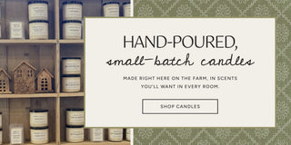 Hand-poured, small-batch candles on the shelves at The Farmhouse